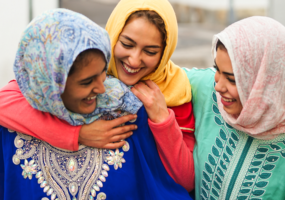 Woman in traditional clothing embracing in Tajikistan