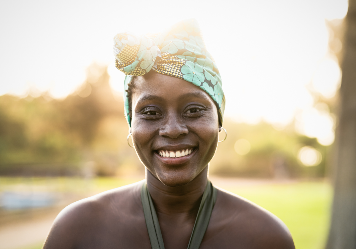 Woman wearing traditional clothing smiling in Gambia