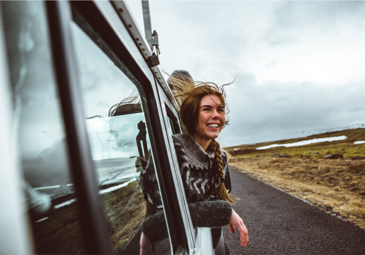 Woman riding in car in Iceland