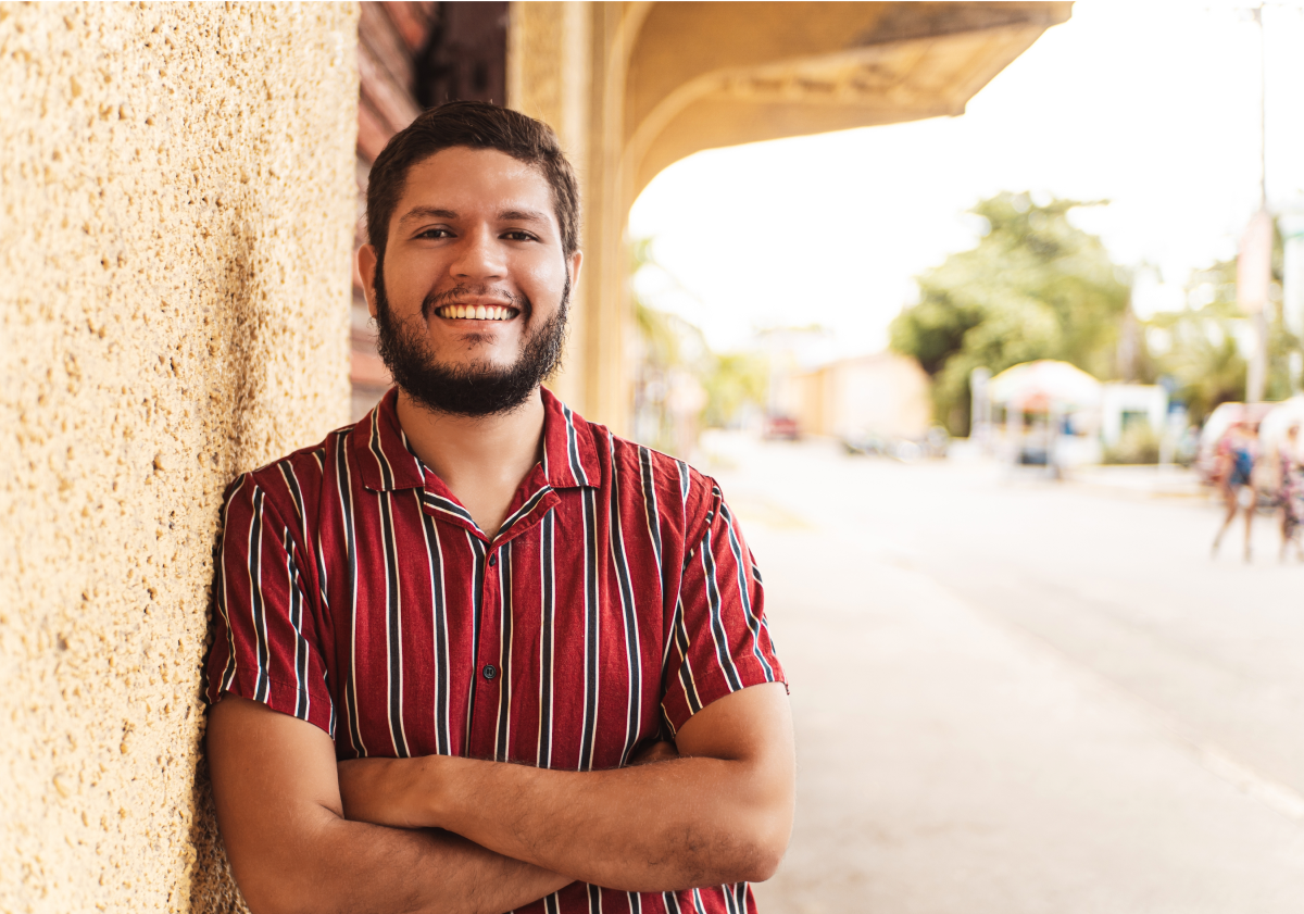 Smiling man standing on sidewalk in Honduras