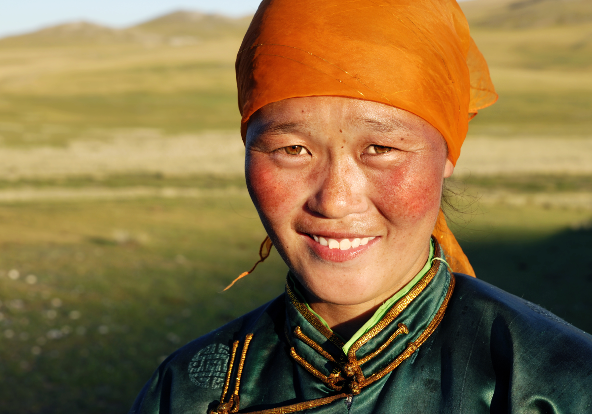 Photo of woman smiling in a field in Mongolia