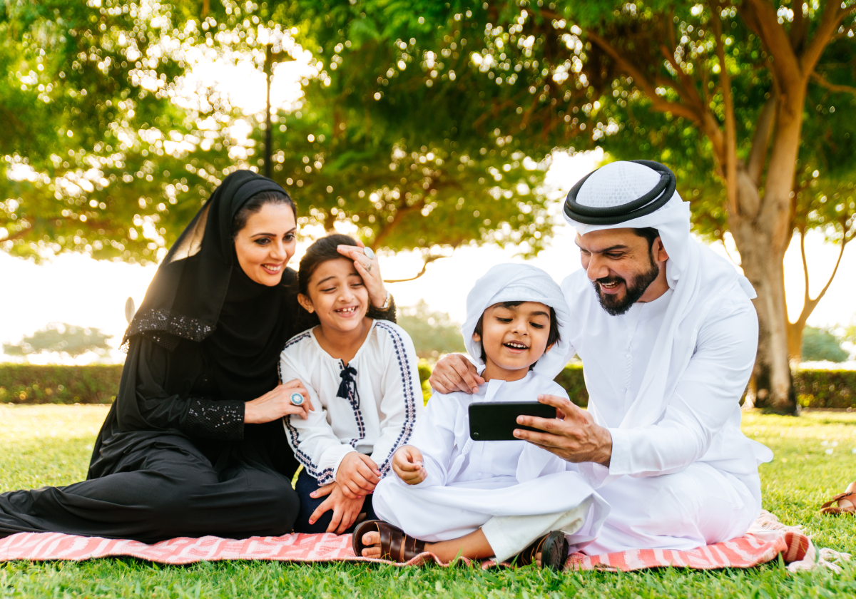 Photo of family sitting in a park in Qatar